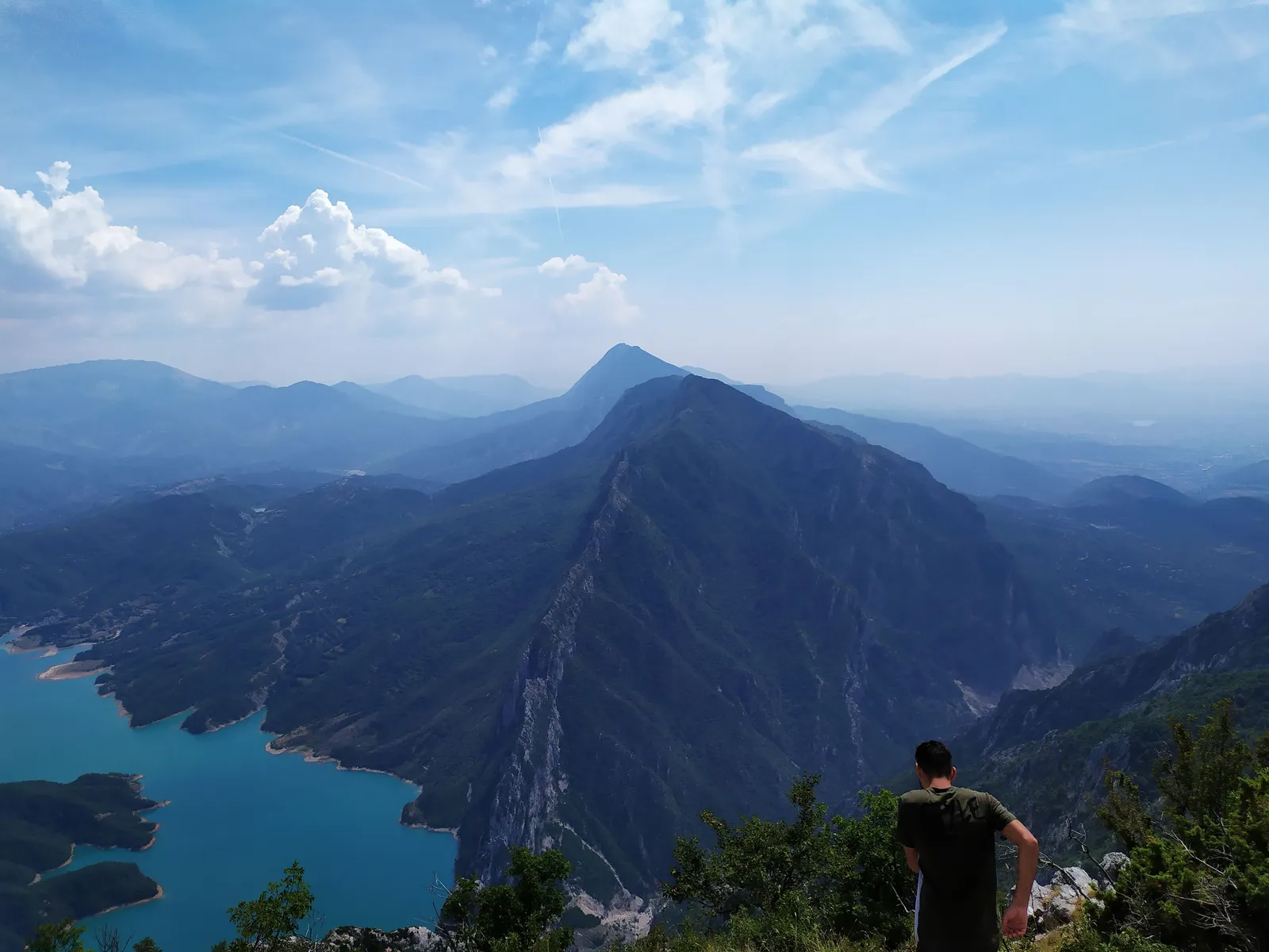 Mountains towering over a turquoise reservoir lake in Albania