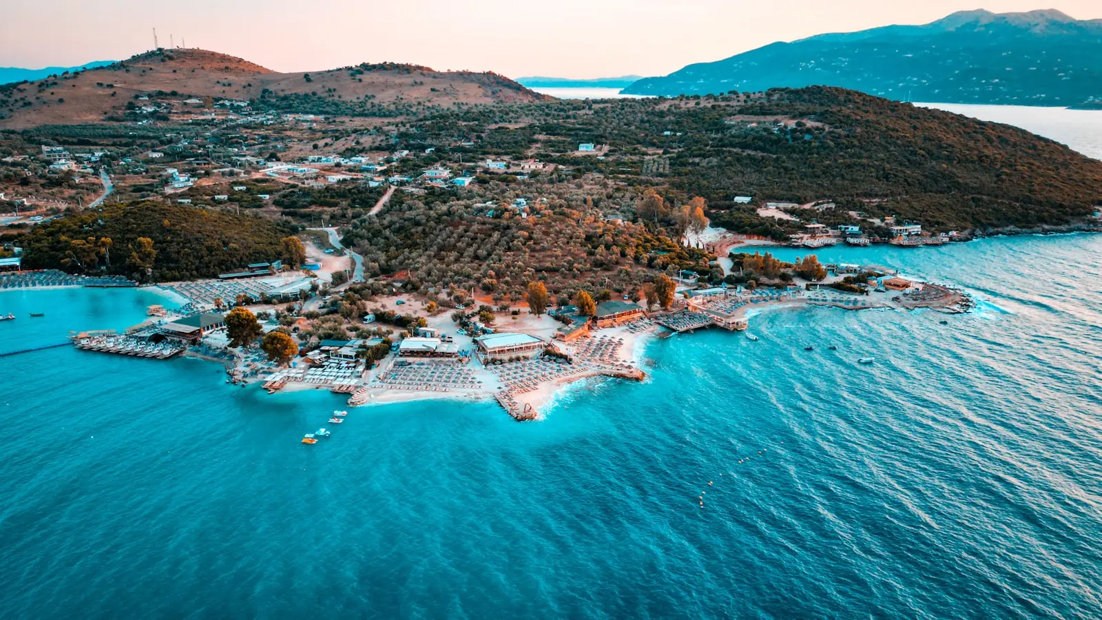 The turquoise coves and pale beaches of the Albanian Riviera seen from a coastal viewpoint on a clear day