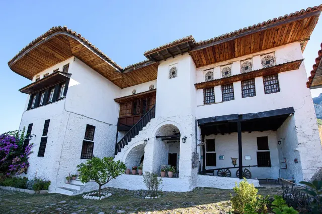 A whitewashed Ottoman mansion with projecting wooden eaves and latticed windows
