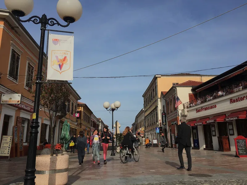 A pedestrian street with colourful facades and cafes