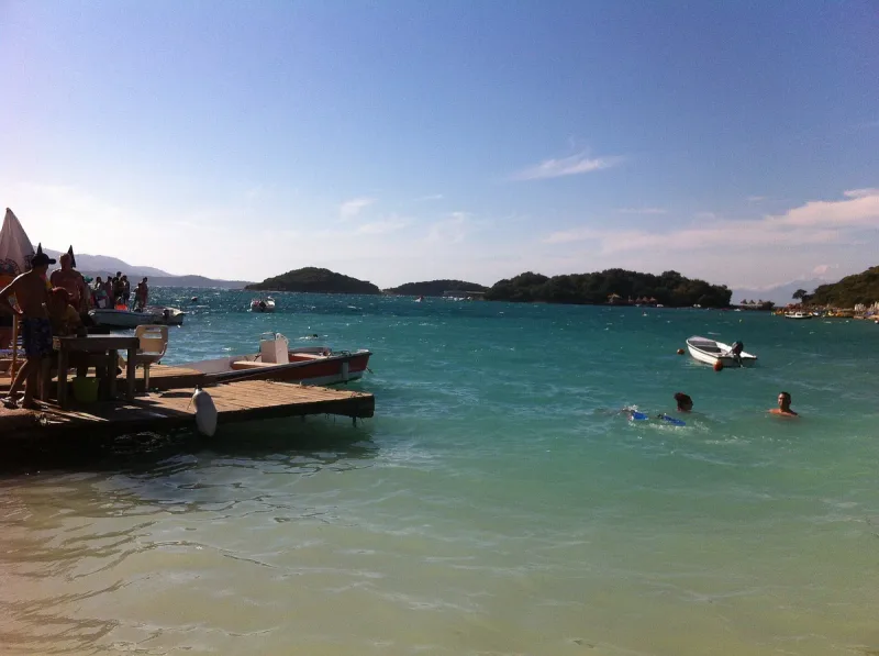 A turquoise bay with a boat and small islets