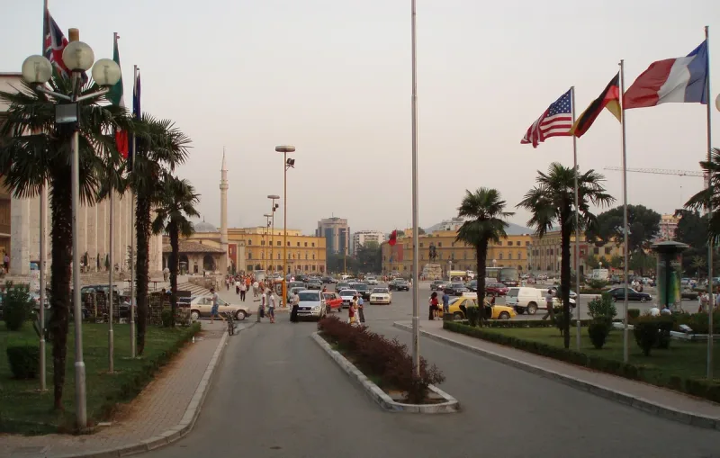 A wide boulevard with flags and public buildings