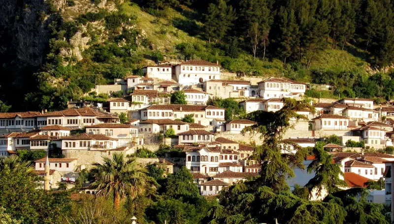 Stone houses with many windows on a slope