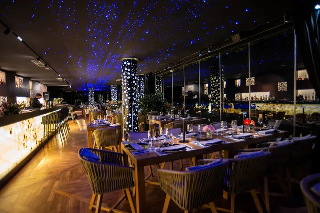 A set restaurant hall with a ceiling twinkling like a starry sky and glass walls