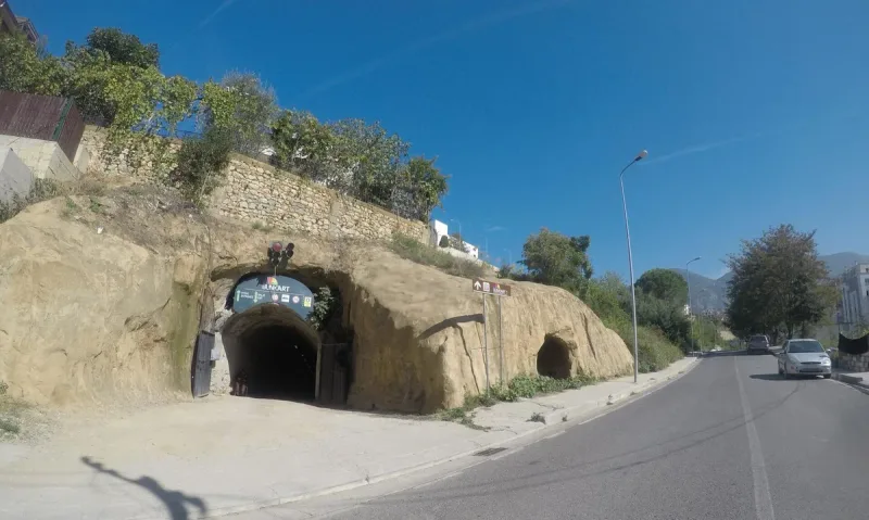 An arched tunnel entrance beside the road