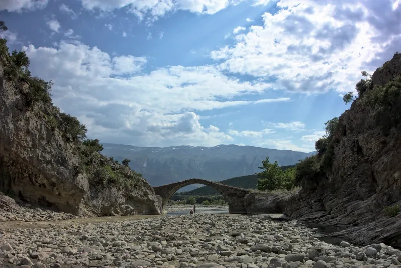 A stone arch bridge over a river gorge