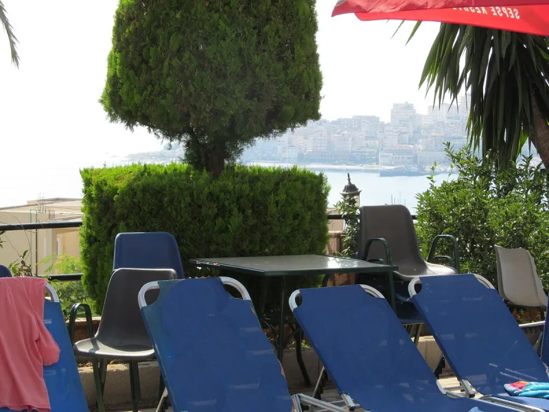 A terrace of sun loungers facing the bay