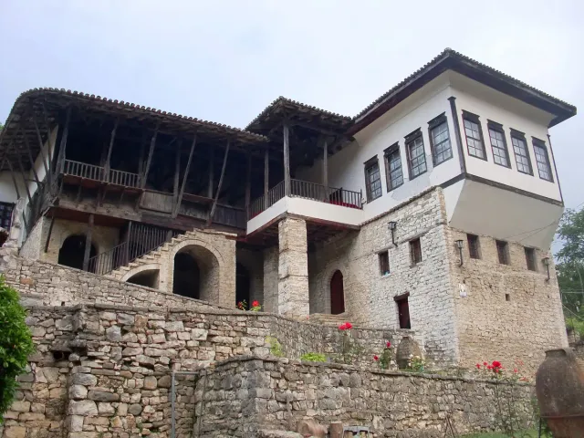 A white Ottoman house with a projecting upper floor and many wooden windows