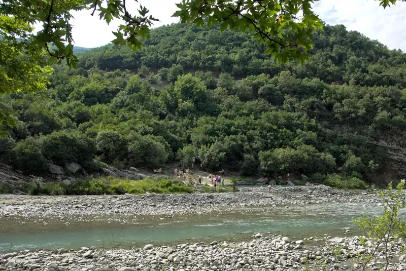 Stone pools on a riverbank between hills