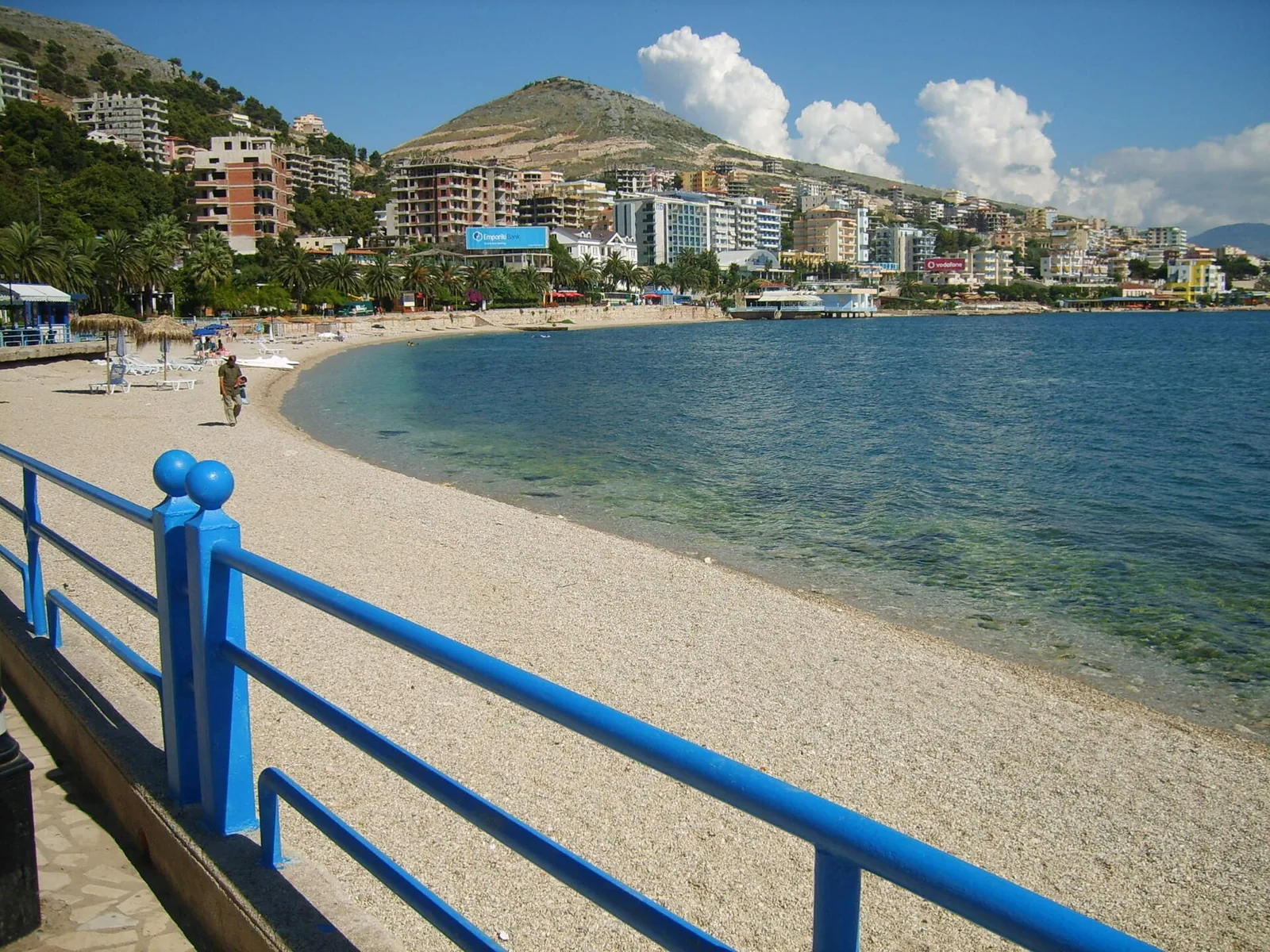 The beach and promenade of Saranda curving around the bay with the town behind, Albania